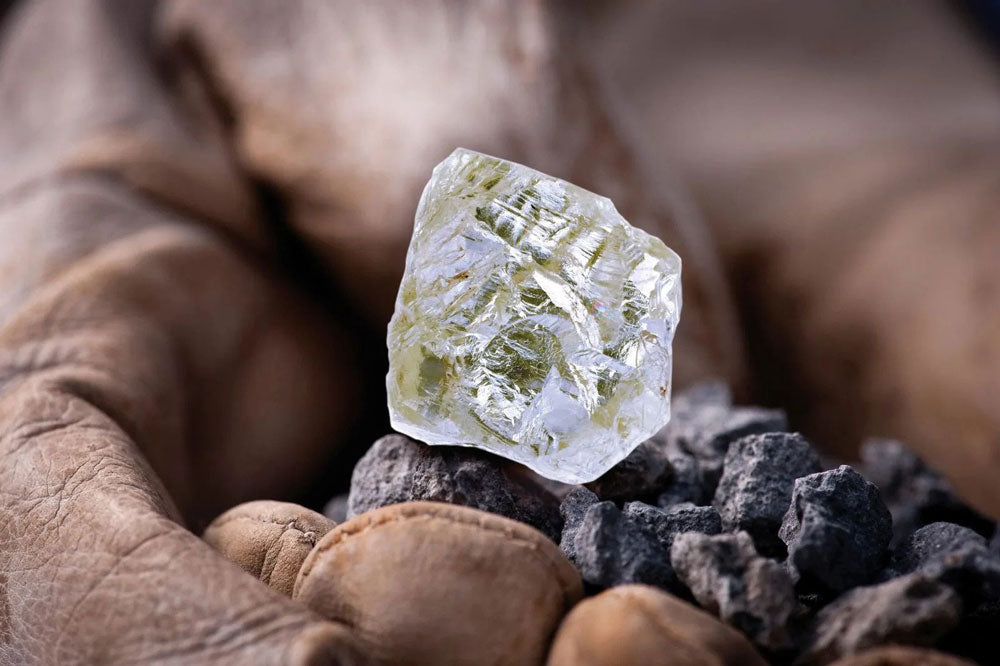 Unless you are well-trained, the best way to identify an uncut diamond is  to take it to a jeweler.